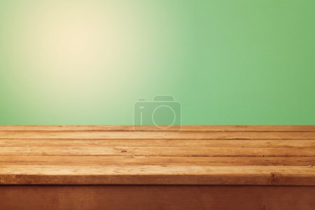 Wooden table and green background