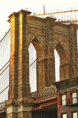 Close up of a pillar of the Brooklyn bridge at sunset
