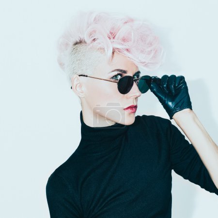 blond model in vintage glasses with stylish haircut. fashion pho