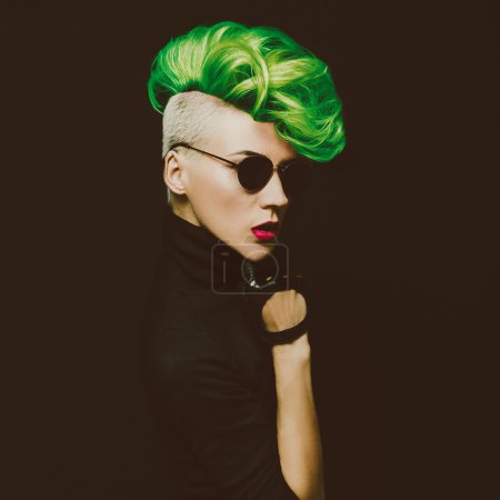 lady with fashionable haircut Colored hair on a black background