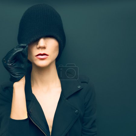 Stylish sexy model on black background in trendy gloves and jack