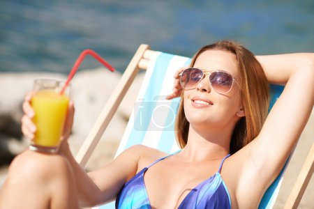 Woman relaxing in deck-chair