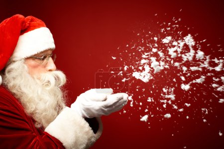 Santa Claus blowing snow