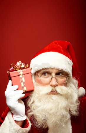 Santa Claus holding  gift boxes