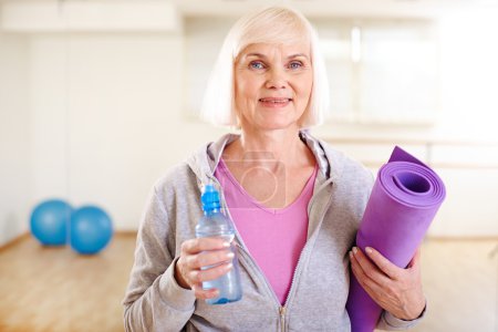 Mature woman with bottle of water