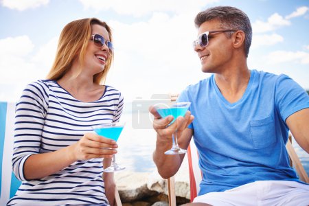 Couple  drinking martini on beach
