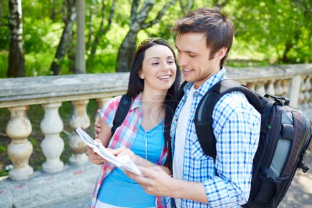 Affectionate couple studying map