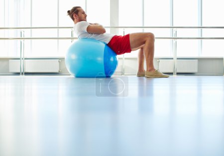 Man exercising with ball