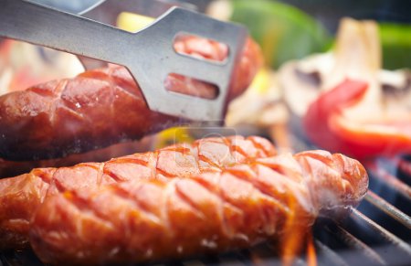 Grilling Sausages on barbecue grill