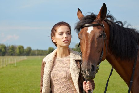 Attractive young woman with a horse