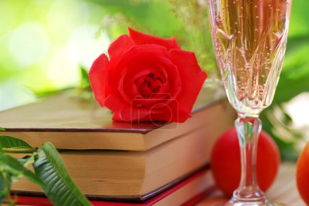 rose on book and glass of rose wine