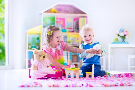 Kids playing with stuffed animals and doll house