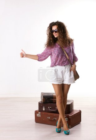 Young woman with suitcases