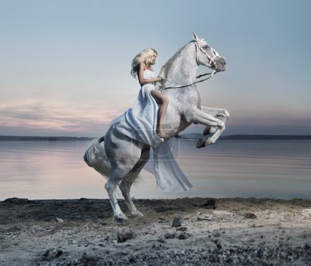 Amazing portrait of blond woman on the horse