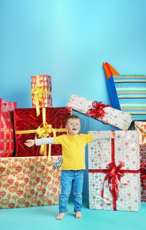Cute little boy with plenty of gifts