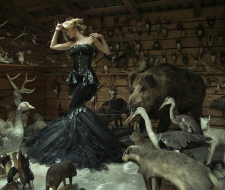 Sensual woman in a locked room full of wild animals