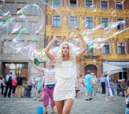 Pretty young blonde among lots of bubbles