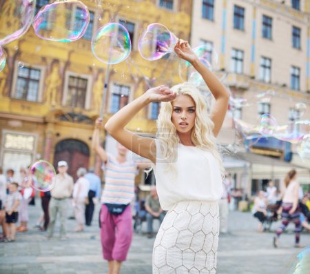 Attractive young lady posing with bubbles