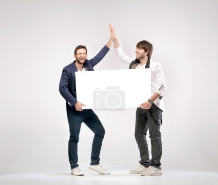 Two handsome friends giving each other a high-five