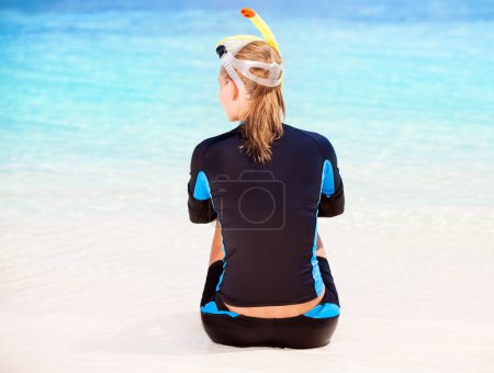 Calm diver girl on seashore