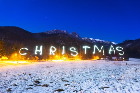 Christmas sign under Tatra mountains at night