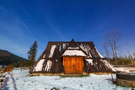 Wooden shelter in Tatra mountains at night