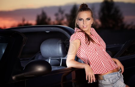 Beautiful woman on black cabriolet