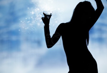 Dancing silhouettes of women with champagne in a nightclub