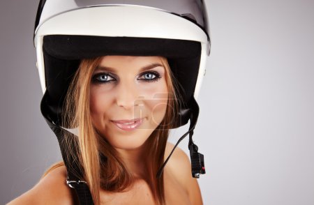 Sexy woman with a white motrcycle helmet and surprised expressio