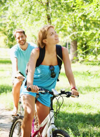 Young happy couple riding a bicycle