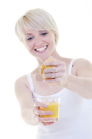 Young woman squeeze orange juice