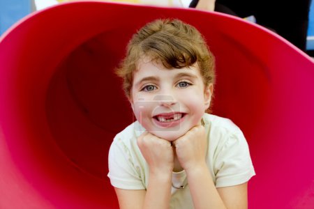 Brunette indented girl smiling in red playground