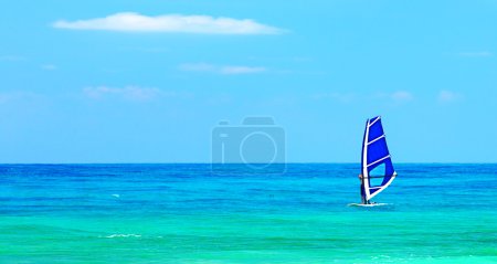 Panoramic beach landscape with windsurfer playing