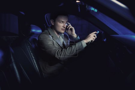 Elegant man driving and talking over cellphone