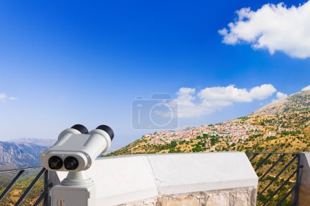Binoculars and Arachova on mountain Parnassos, Greece