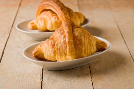 Croissants on wooden table