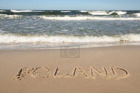 Poland - country name drawn on a beach