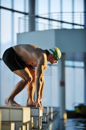 Young swimmmer on swimming start