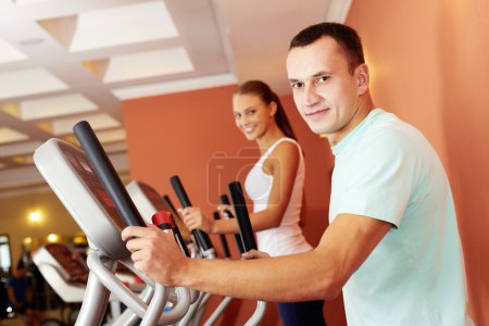 Young couple training in gym