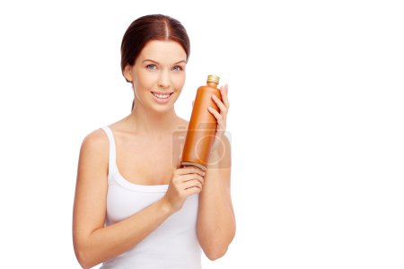 Woman showing sun protective body lotion