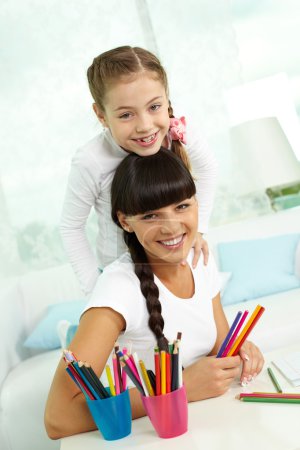 Girl and mother with colorful pencils