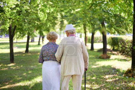 Senior couple walk in park