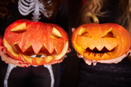 Halloween pumpkins on female palms