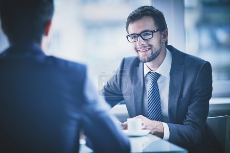 Businessman having talk with his colleague