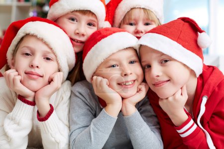 Happy kids in Santa caps