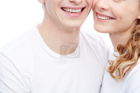 Young couple with toothy smiles