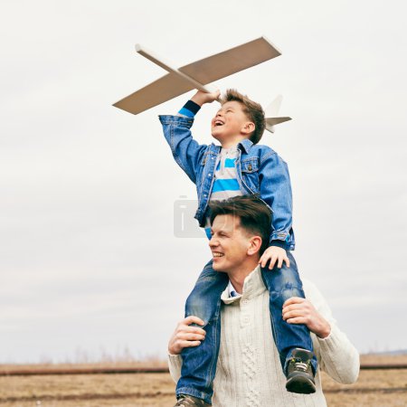 Father and son with toy airplane