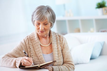 Senior woman making notes