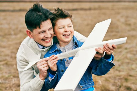 Father and son with toy airplane