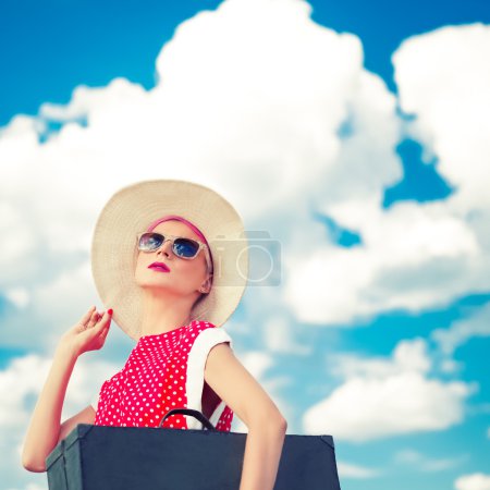 Retro girl on the blue sky background